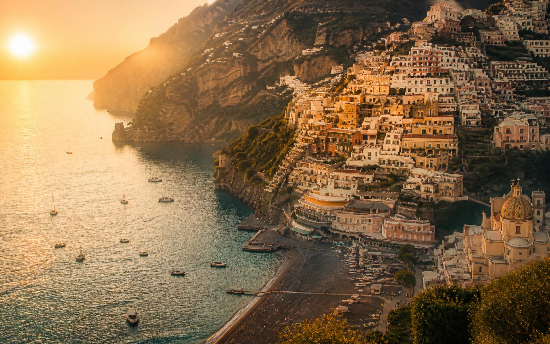 Positano cliffs glowing at golden hour above the Mediterranean